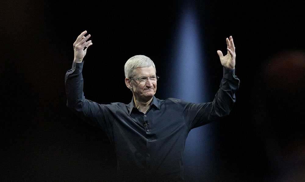 Apple CEO Tim Cook gestures while speaking at the Apple Worldwide Developers Conference in San Francisco, Monday, June 2, 2014. Apple's Mac operating system is getting a new design and better ways to exchange files, while new features in the software for iPhones and iPads include one for keeping tabs on your health. (AP Photo/Jeff Chiu)