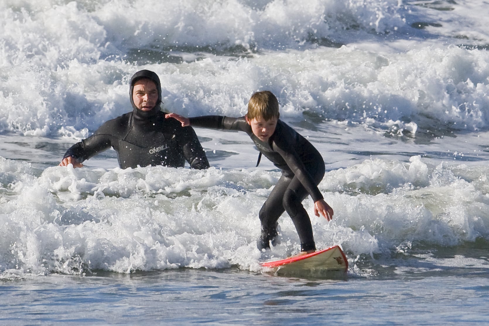 Father and son surf lesson in Morro Bay, CA