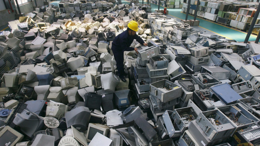An employee arranges discarded computers at a newly opened electronic waste recycling factory in Wuhan