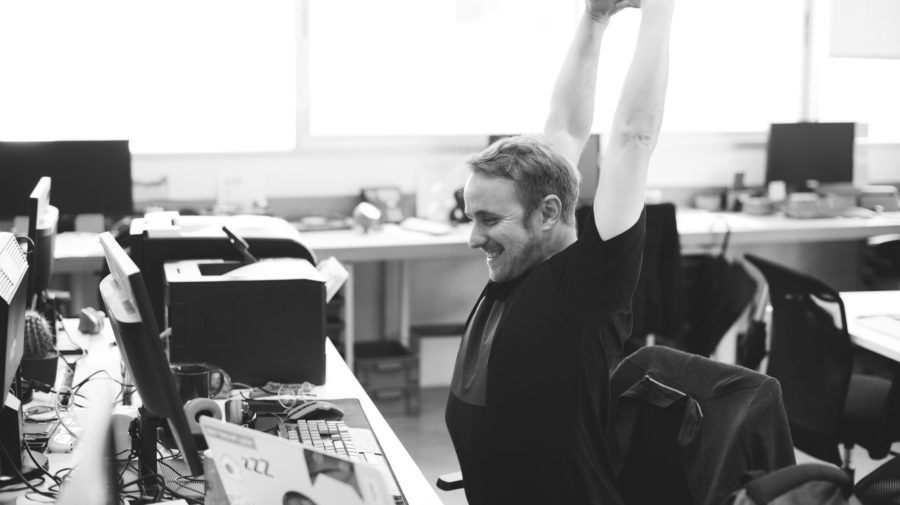 Man Stretching Arms during Break Time at Office