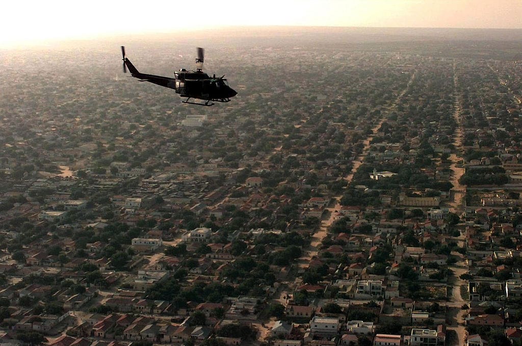 1024px-Aerial_view_of_a_US_helicopter_as_it_flies_over_a_Mogadishu_residential_area