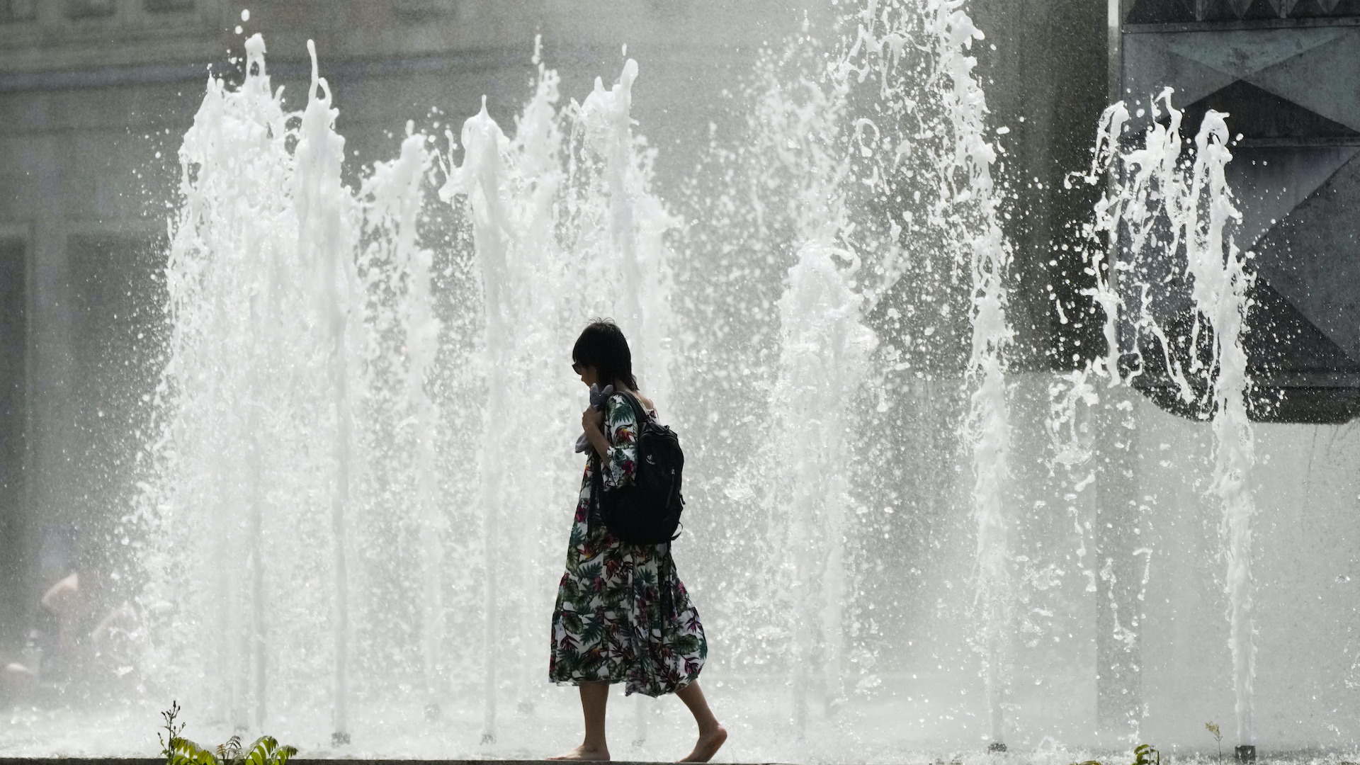 horúčavy žena prechádza cez fontánu