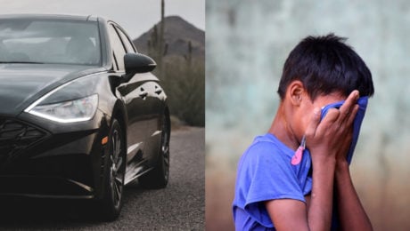 Čierny Hyundai pripravený na cestu stojí na peknej dlažobnej ulici. Smutný chlapec v modrom tričku si drží tvár