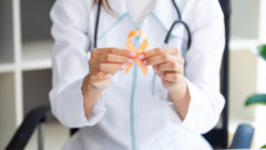 doktorka drží oranžovú stužku