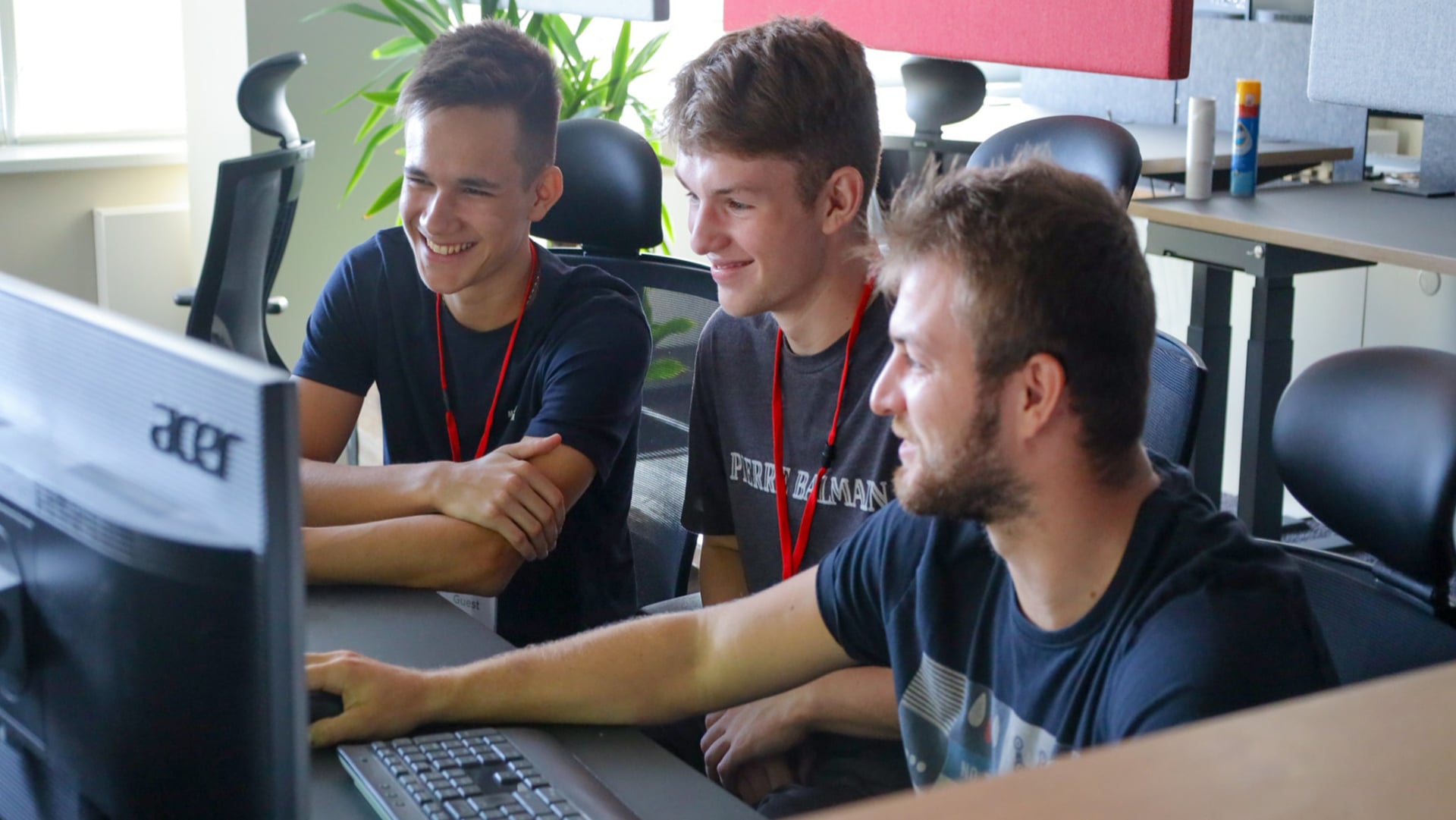 Žiaci sedia za počítačom a smejú sa