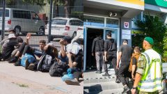 Na snímke zadržaní migranti a migranti v sprievode policajta prichádzajú na na Oddelenie cudzineckej polície.