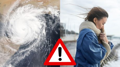 Pohľad na orkán a žena stojí v prístave, kde fúka vietor.