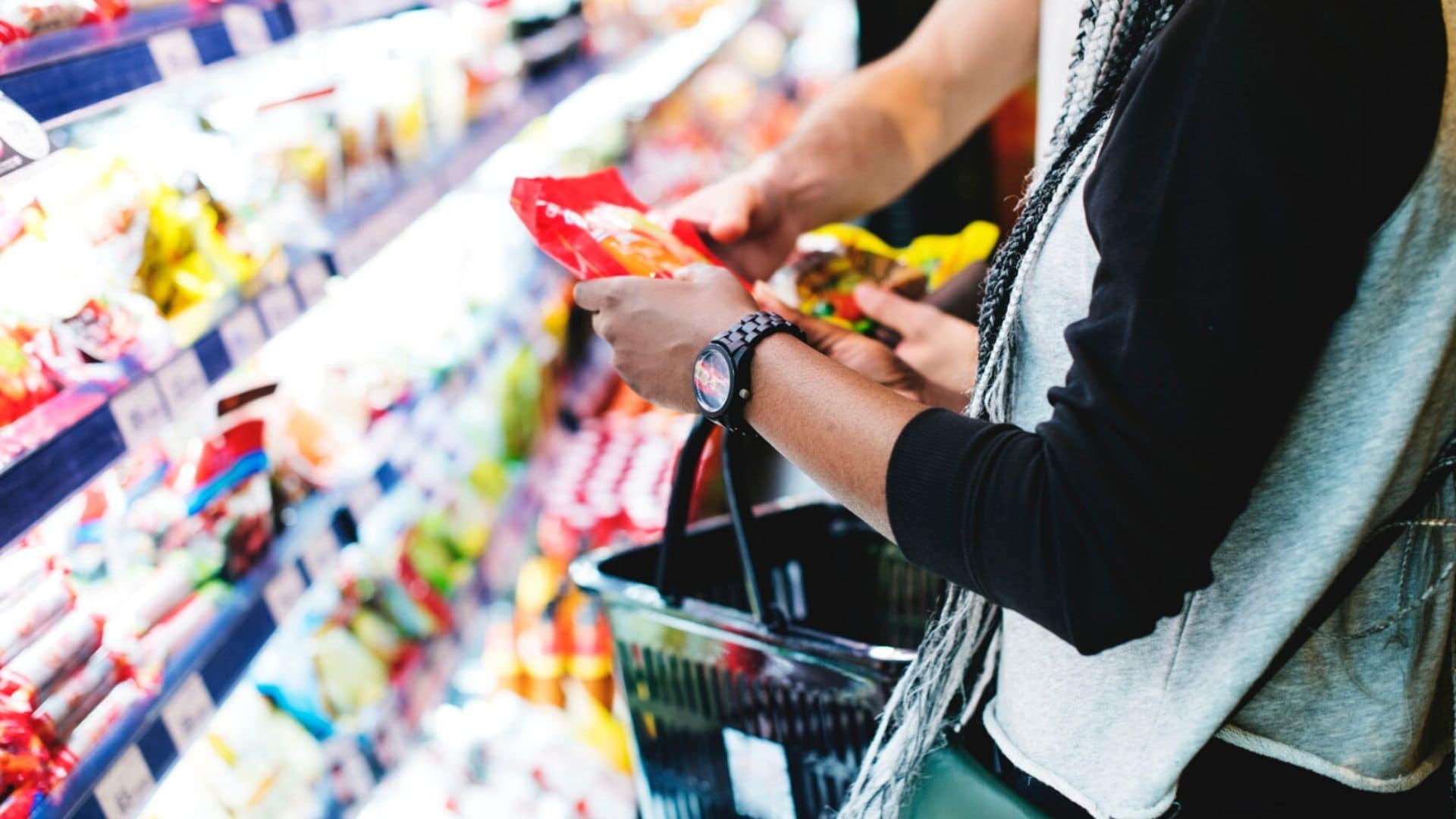 Žena s košíkom nakupuje v potravinách.