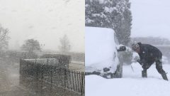 Sneženie a muž odhŕňa pri aute sneh s lopatou.