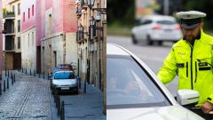 Odparkované autá na ulici a policajt kontroluje vodiča vozidla.