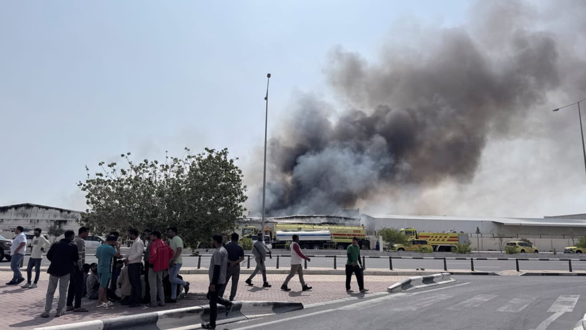 People gather as smoke rises at the Industrial Area after reported Iranian missile attacks, following United States and Israel strikes on Iran, in Doha, Qatar, March 1, 2026