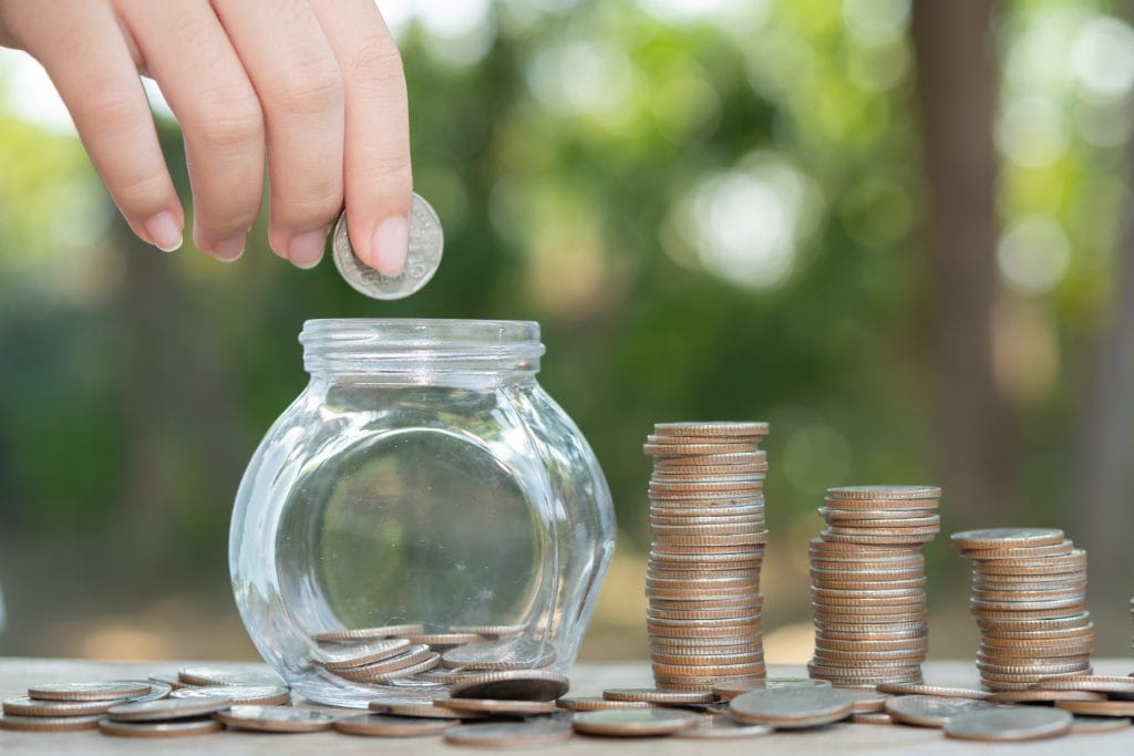 saving-money-concept-preset-by-male-hand-putting-money-coin-stack-growing-business-arrange-coins-into-heaps-with-hands-content-about-money